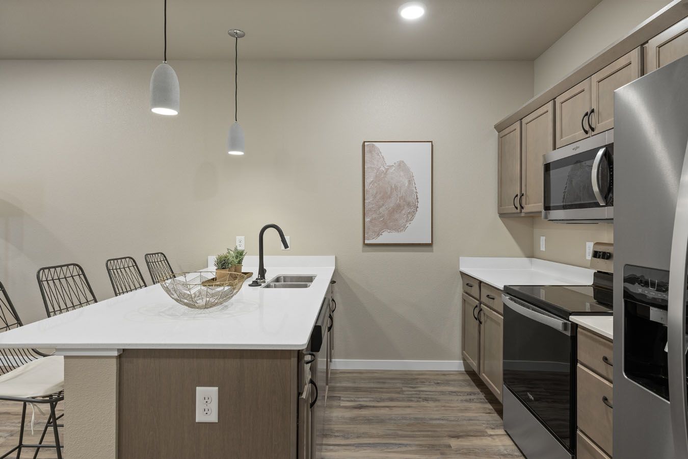 a kitchen with stainless steel appliances and a large island .
