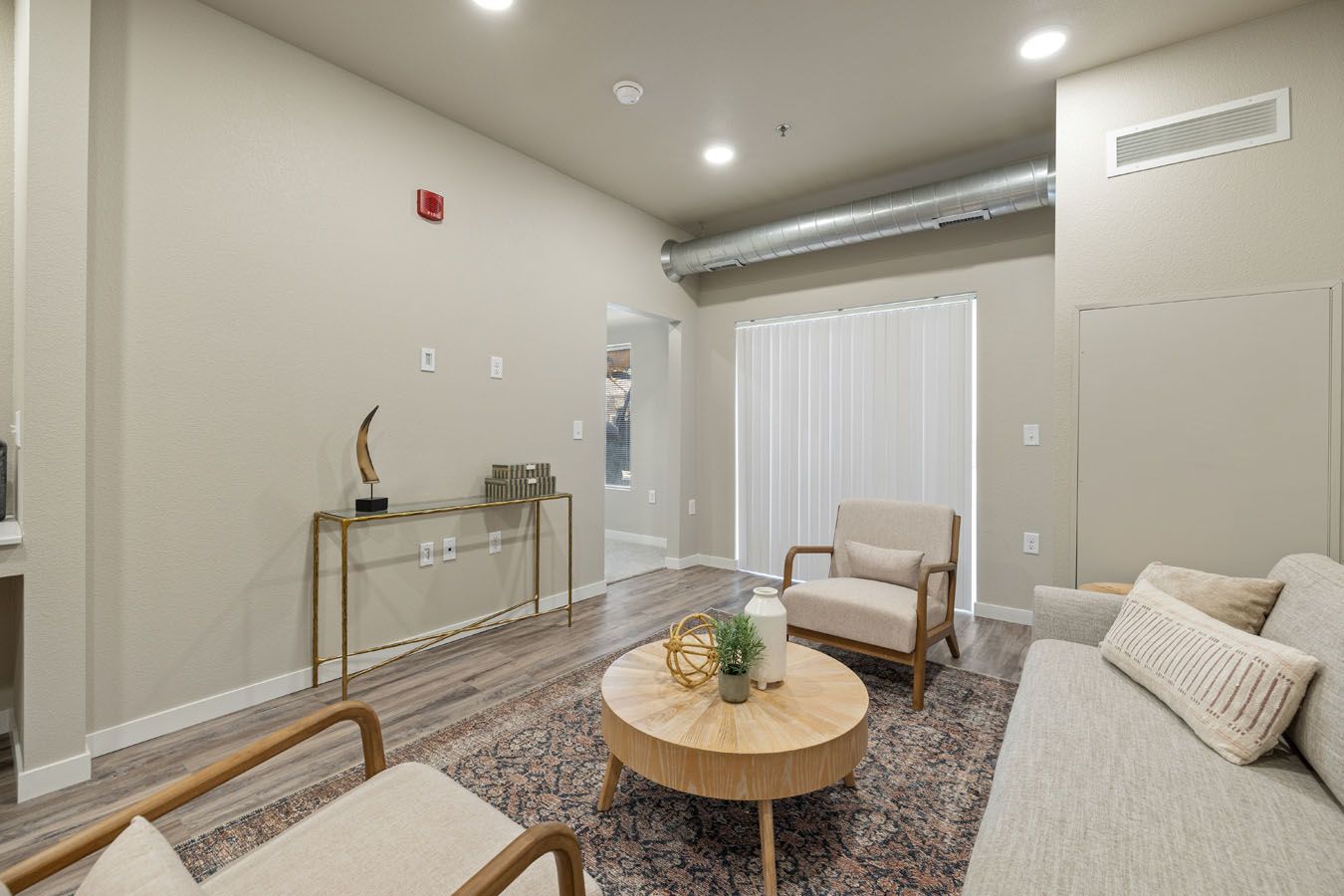 a living room with a couch , chairs , and a coffee table .