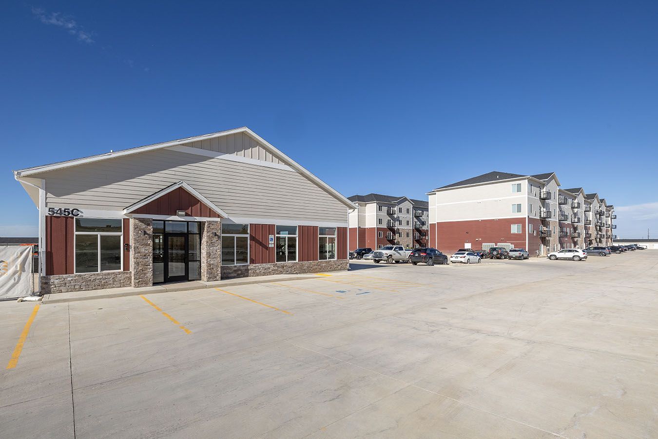 a large building with a lot of cars parked in front of it