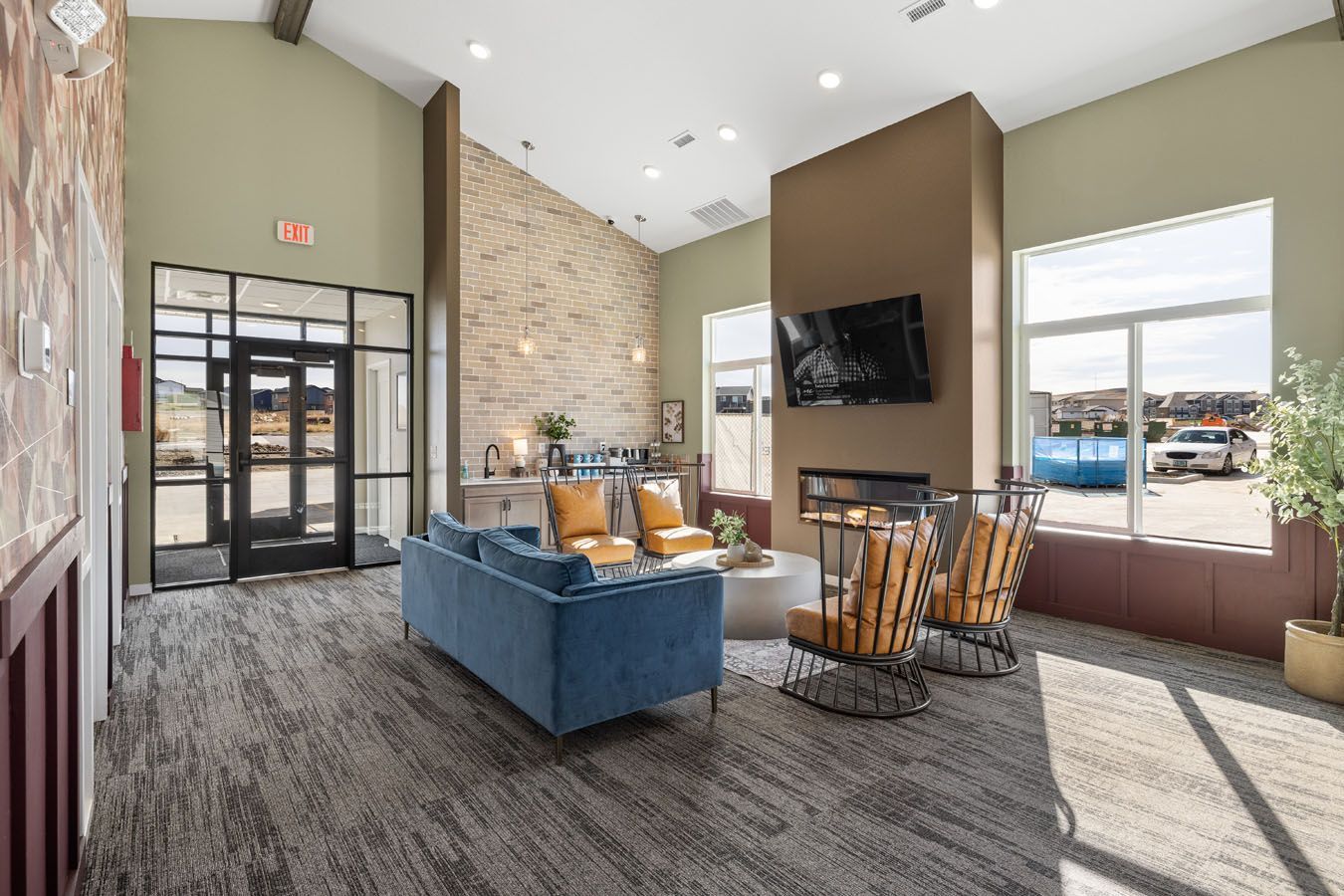 a living room with a couch , chairs , and a fireplace .