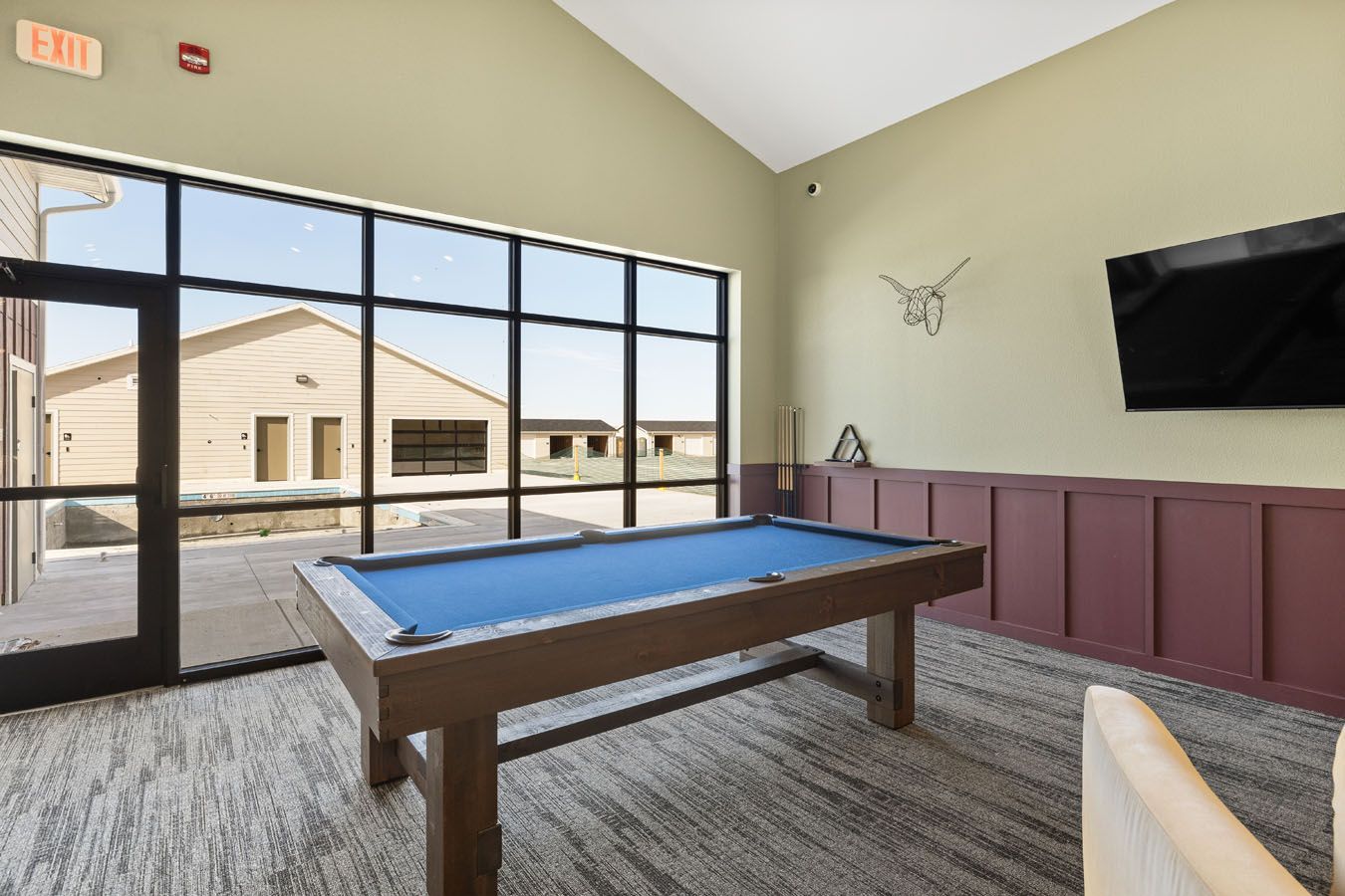 there is a pool table in the middle of the room .