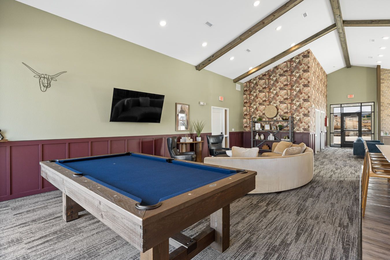 there is a pool table in the middle of the room .