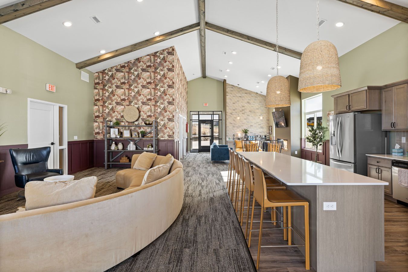 a living room with a couch , chairs , and a long table .