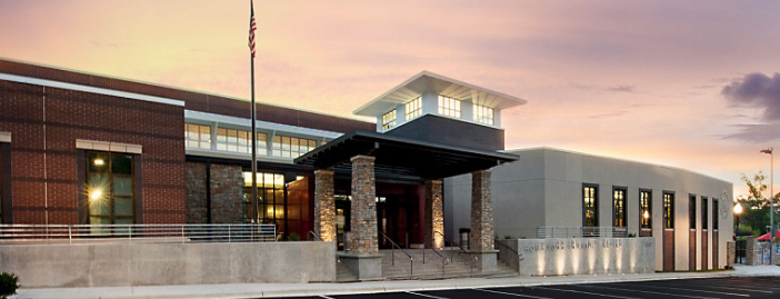 A large building with a flag pole in front of it