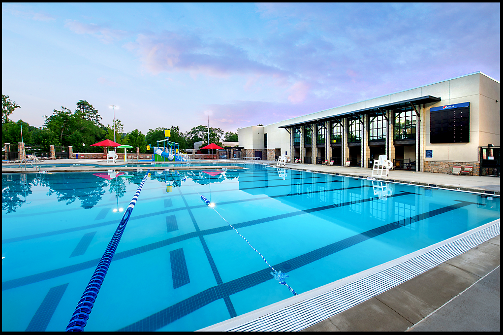 A large swimming pool with a building in the background