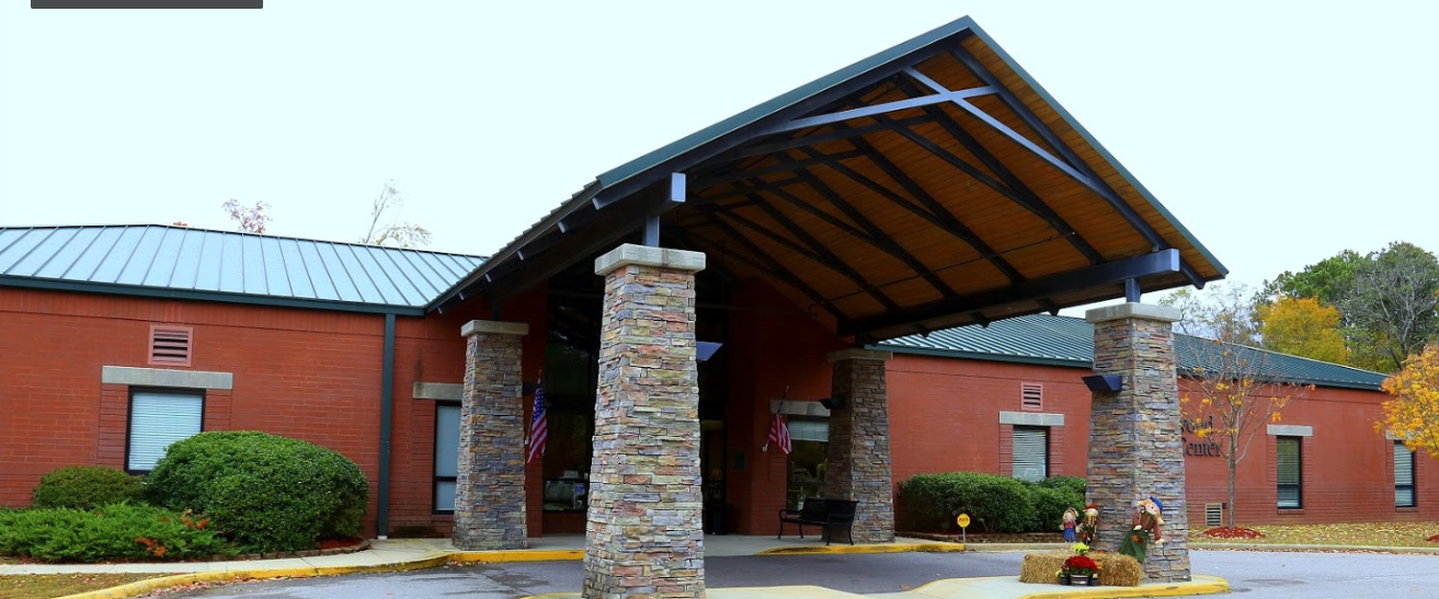 A large brick building with a canopy over the entrance.