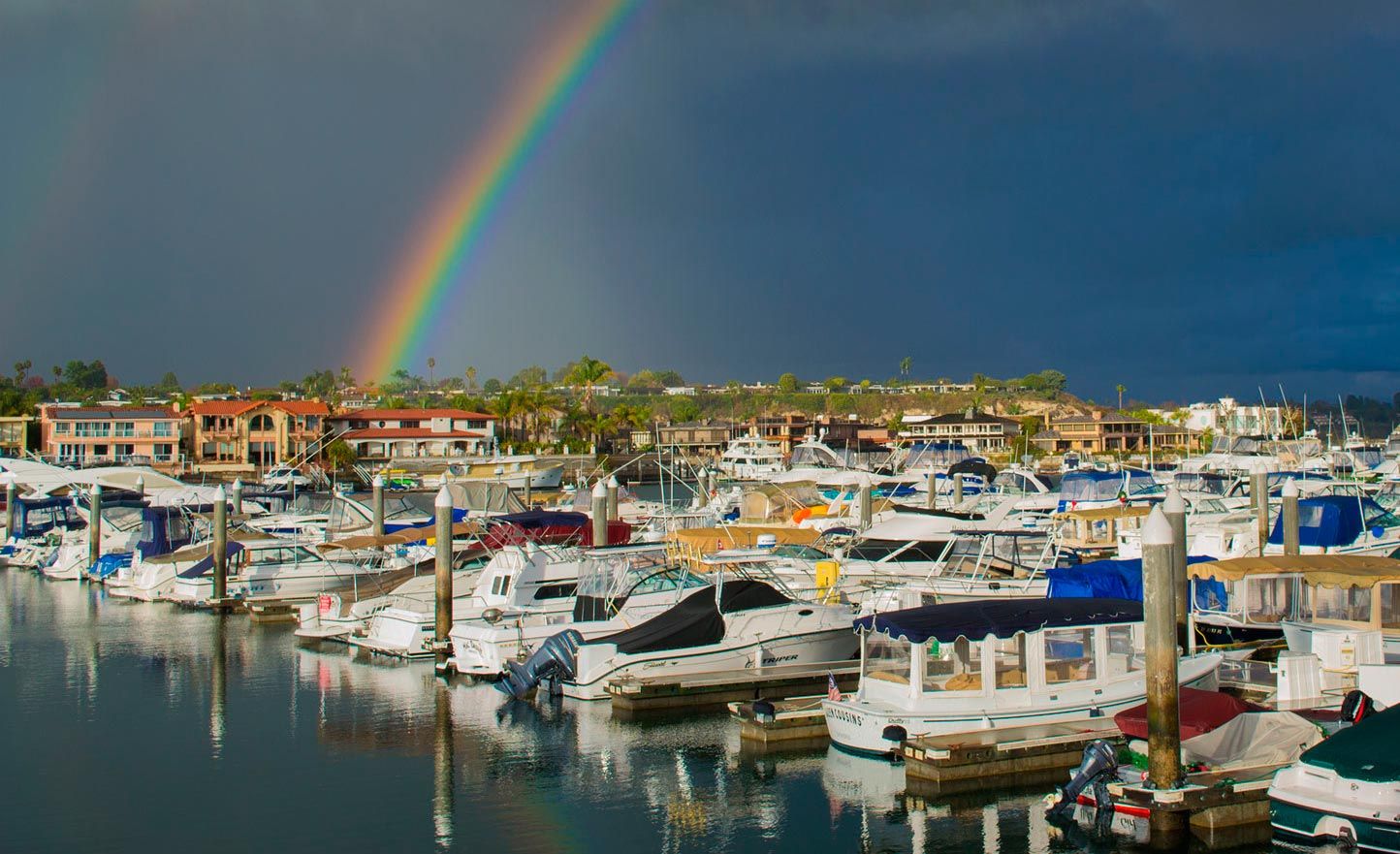 View of the marina looking toward the channel with a rainbow in the background