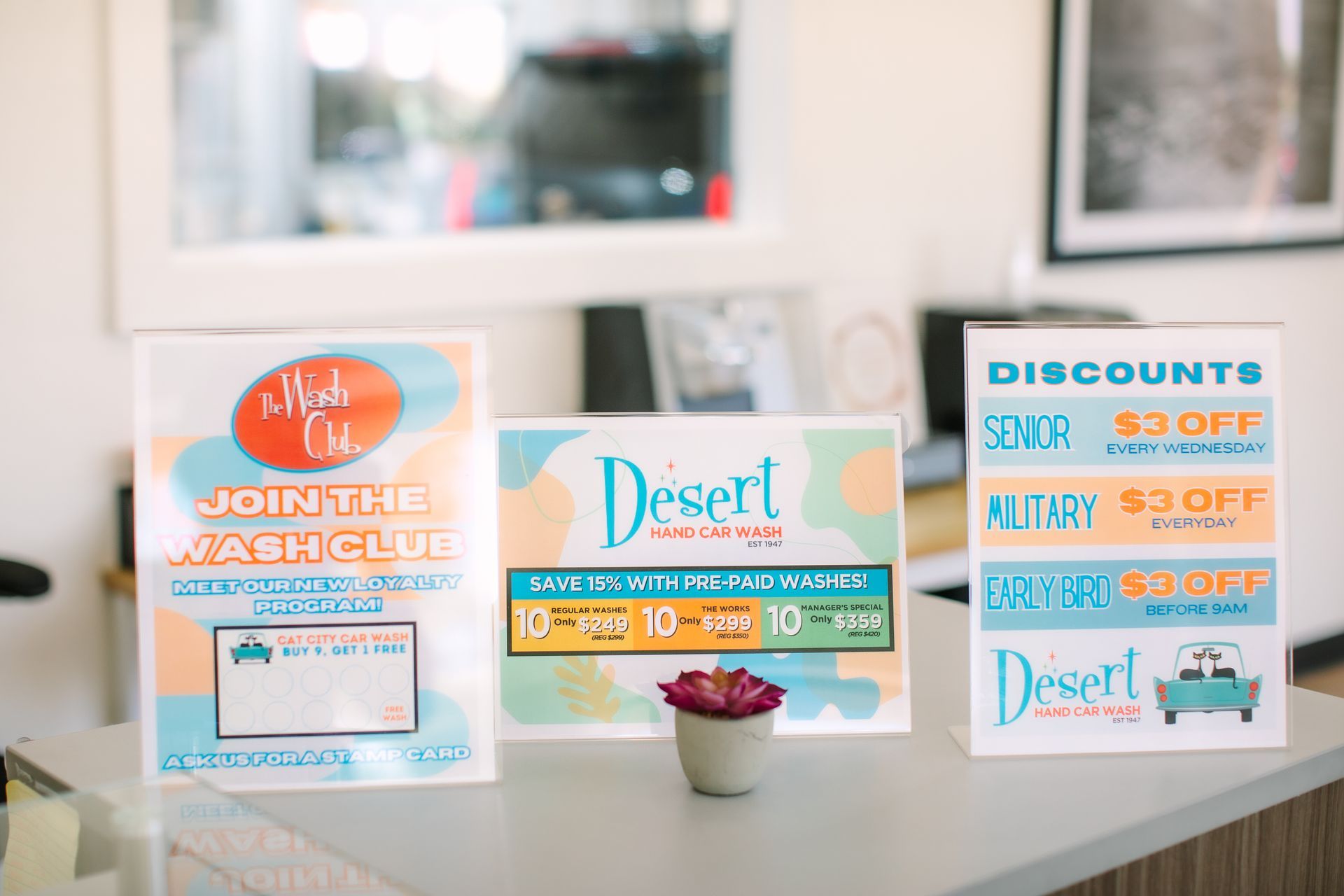 Three signs are sitting on a counter in a room.