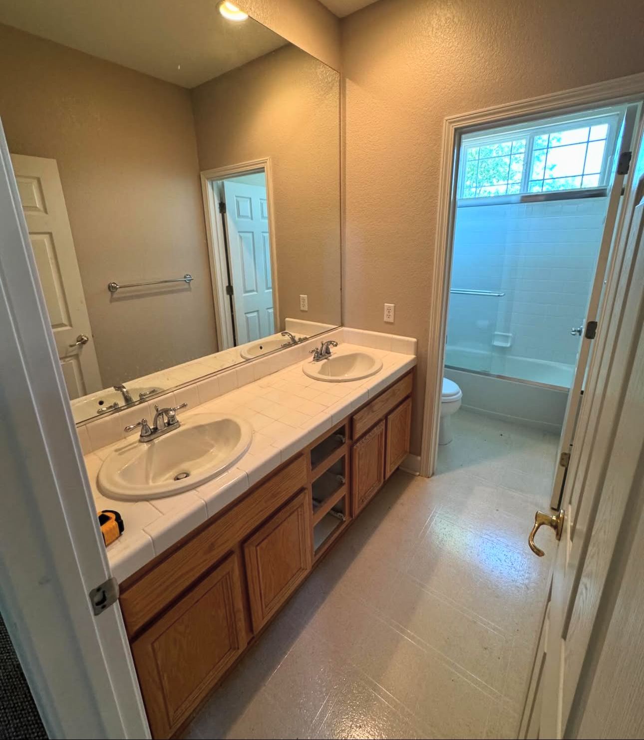 A bathroom with two sinks and a large mirror