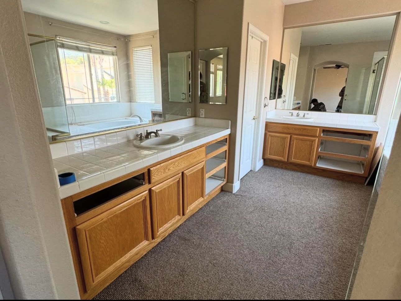 A bathroom with two sinks and two mirrors