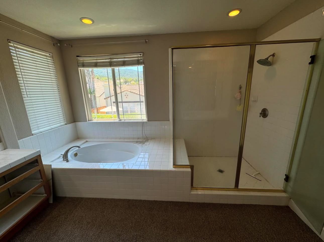 A bathroom with a jacuzzi tub and a walk in shower