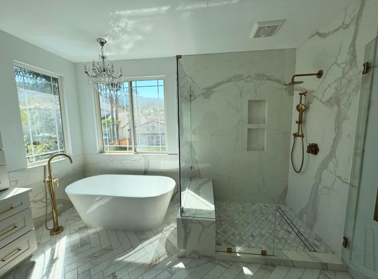 A bathroom with a bathtub and a walk in shower.