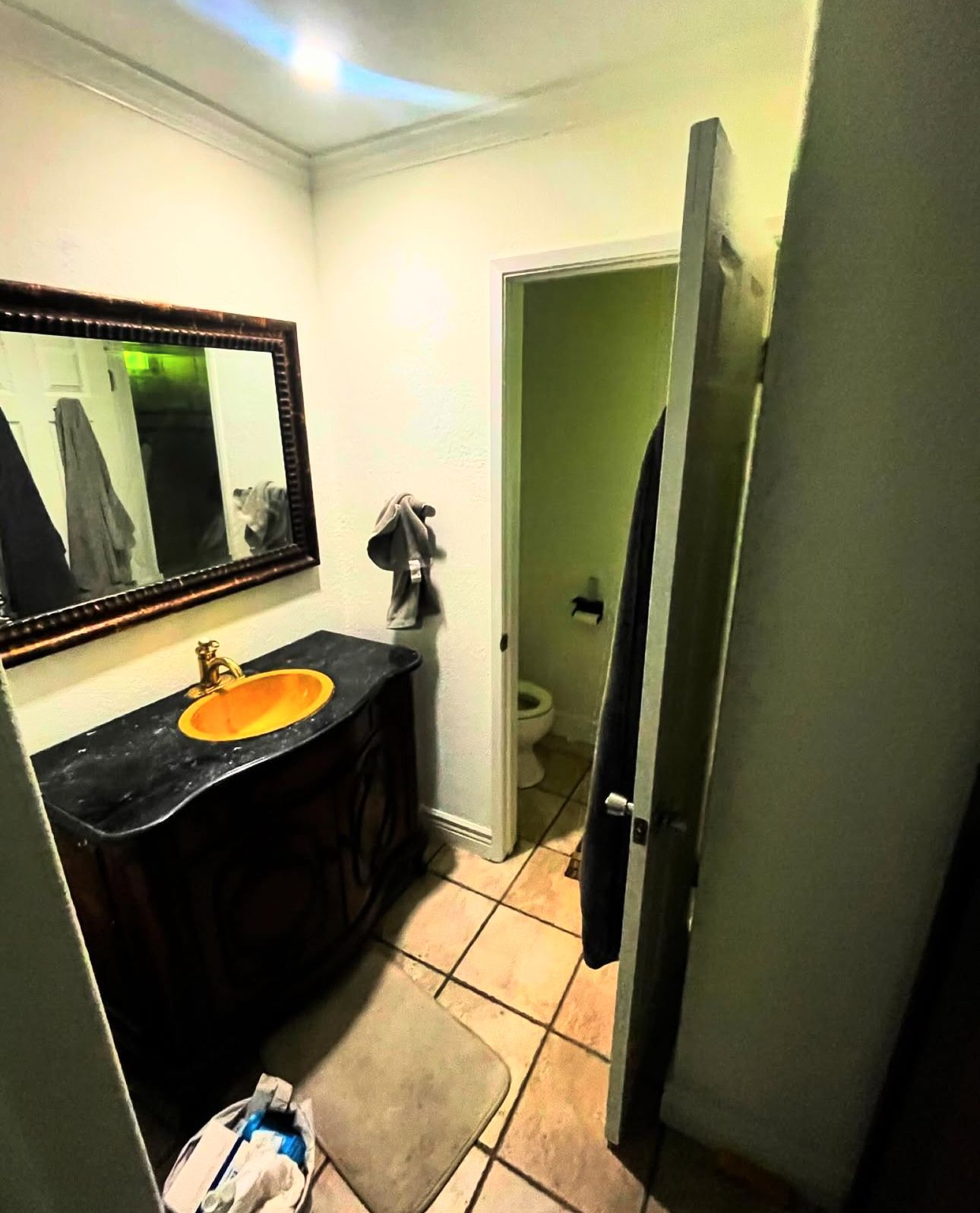 A bathroom with a sink a mirror and a toilet