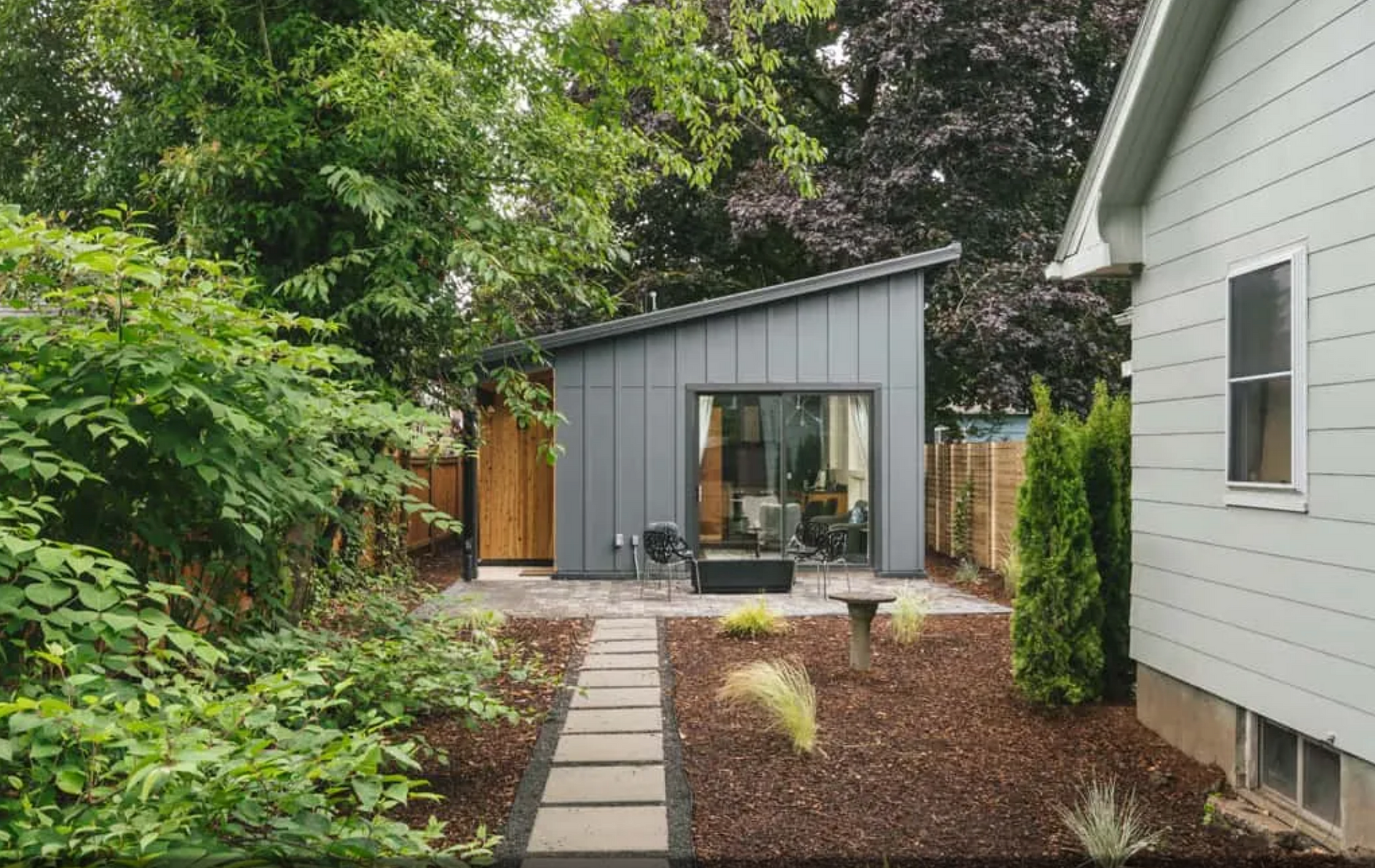 A house with a shed on the side of it