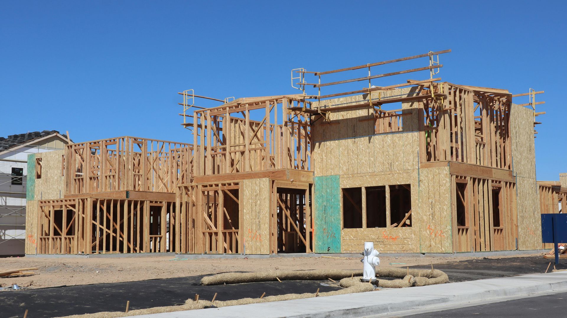 A house that is being built with a fire hydrant in front of it