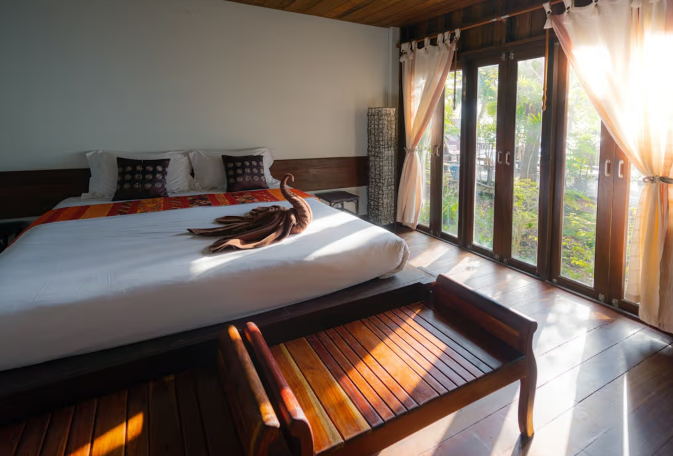 A man and a woman are standing next to a stack of cardboard boxes