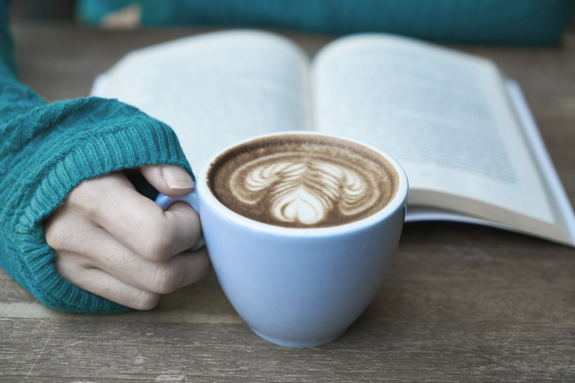 Woman reading book with a cup of coffee