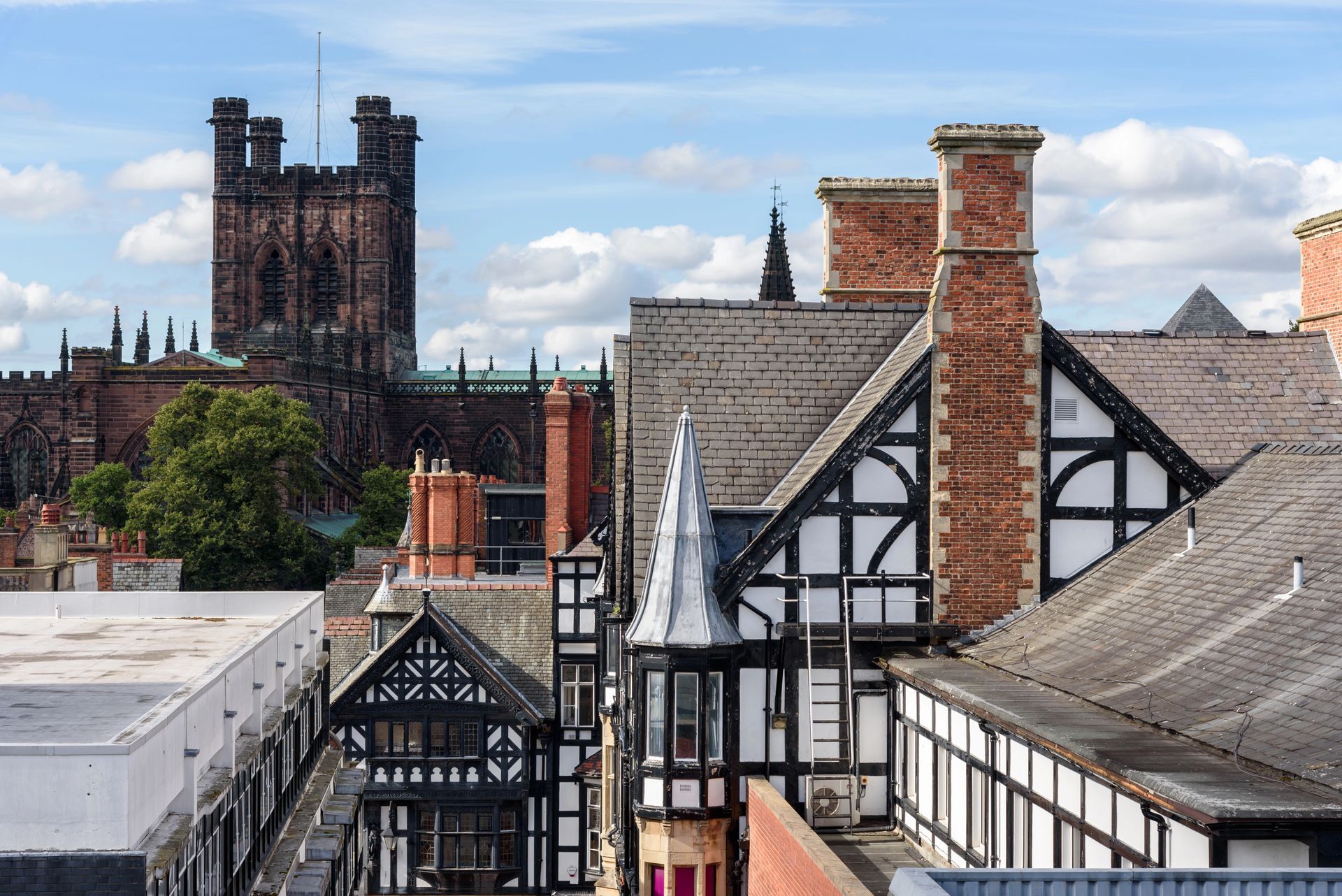 view across period property rooftops in Chester, Cheshire looking towards Chester Cathedral, England