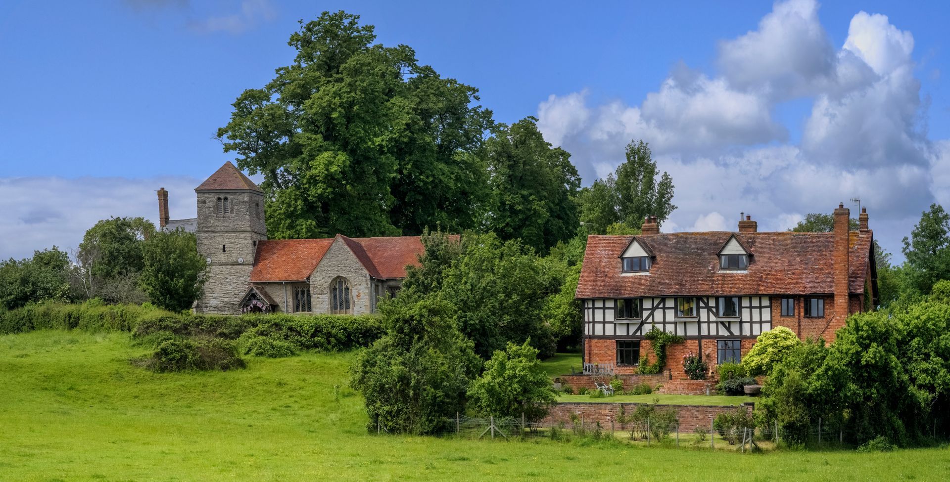 Image of quaint Elizabethian period house by church near Oswestry in Shropshire, England