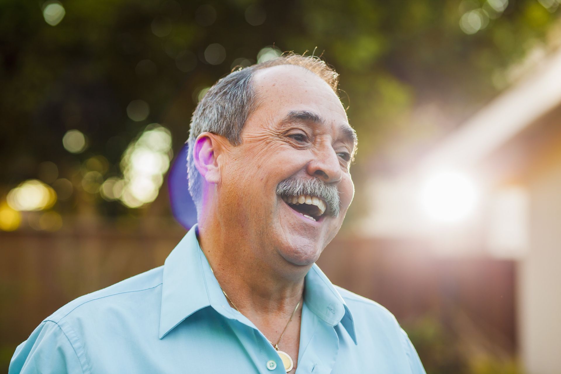 A woman is sitting on a couch with her head in her hands.