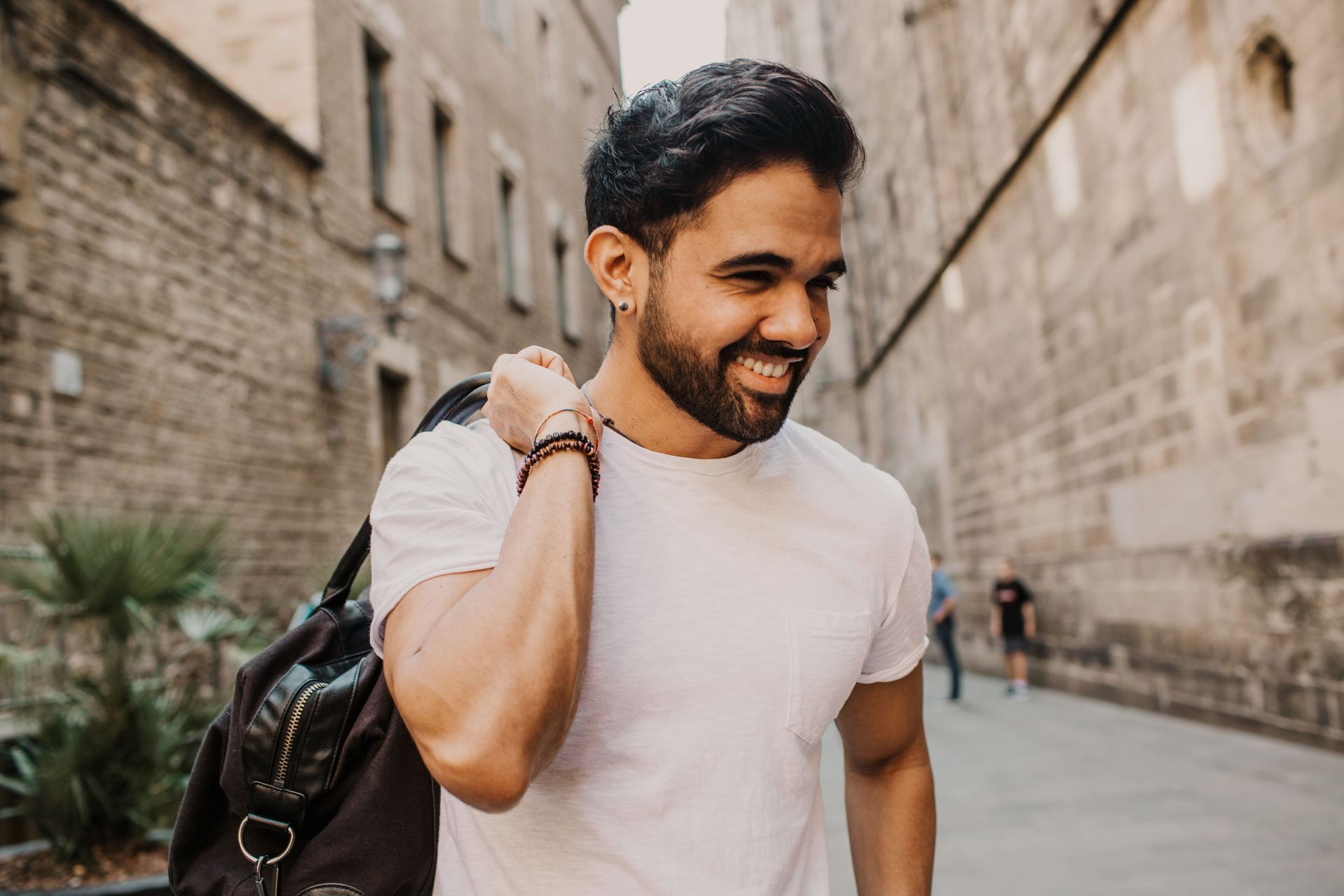 A woman is sitting on a couch with her head in her hands.