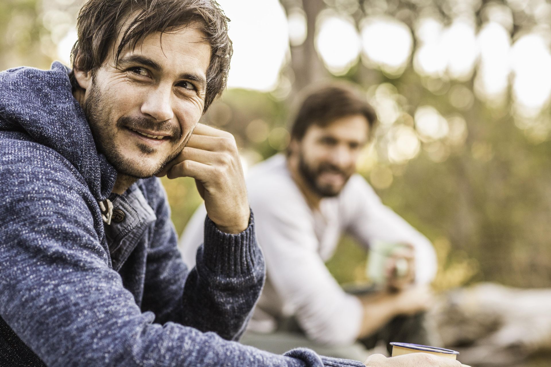 A woman is sitting on a couch with her legs crossed.