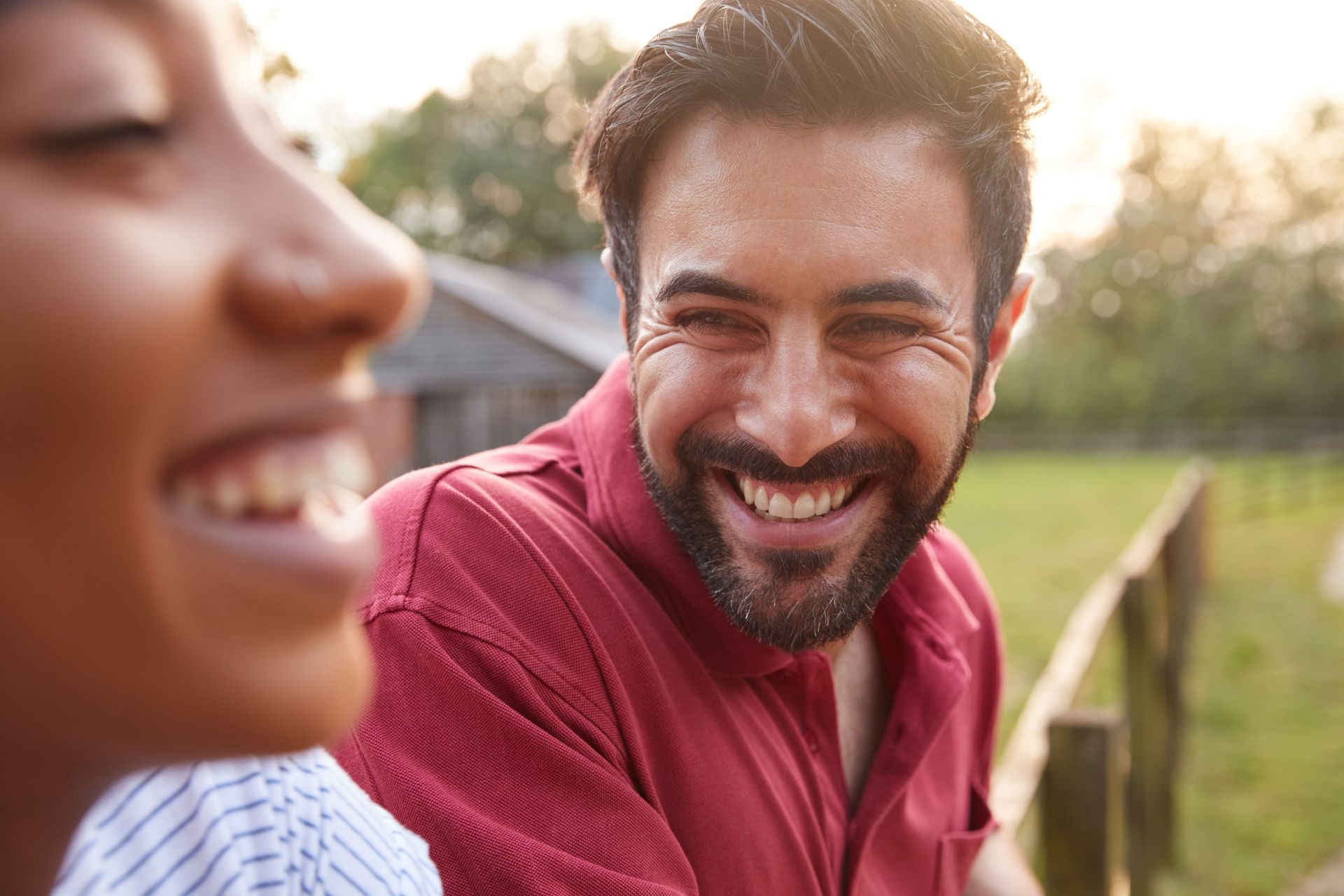 A woman is sitting on a couch with her head in her hands.