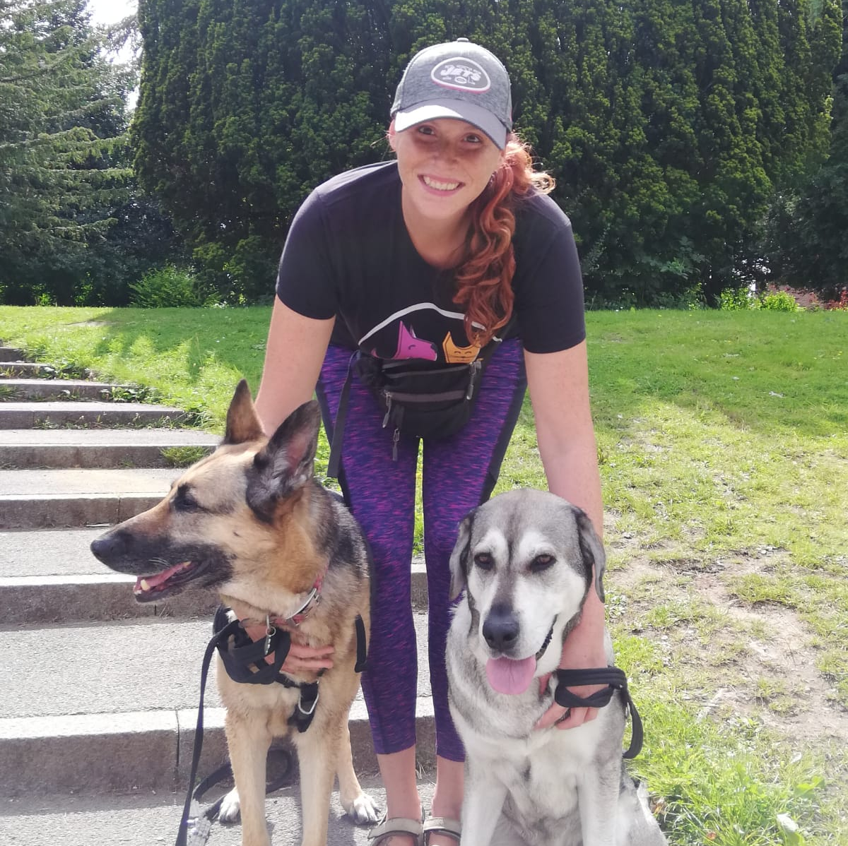 Charli, the owner of Charli's Pet Angels with her two dogs