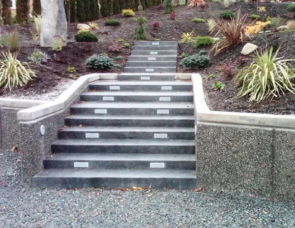 A set of stairs leading up to a lush green hillside