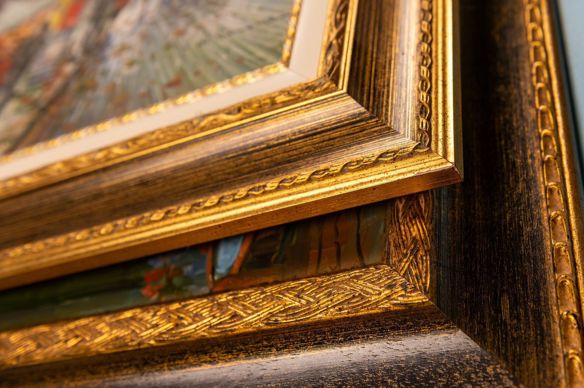 Gold-framed artwork corner, showcasing ornate details and an angled composition.