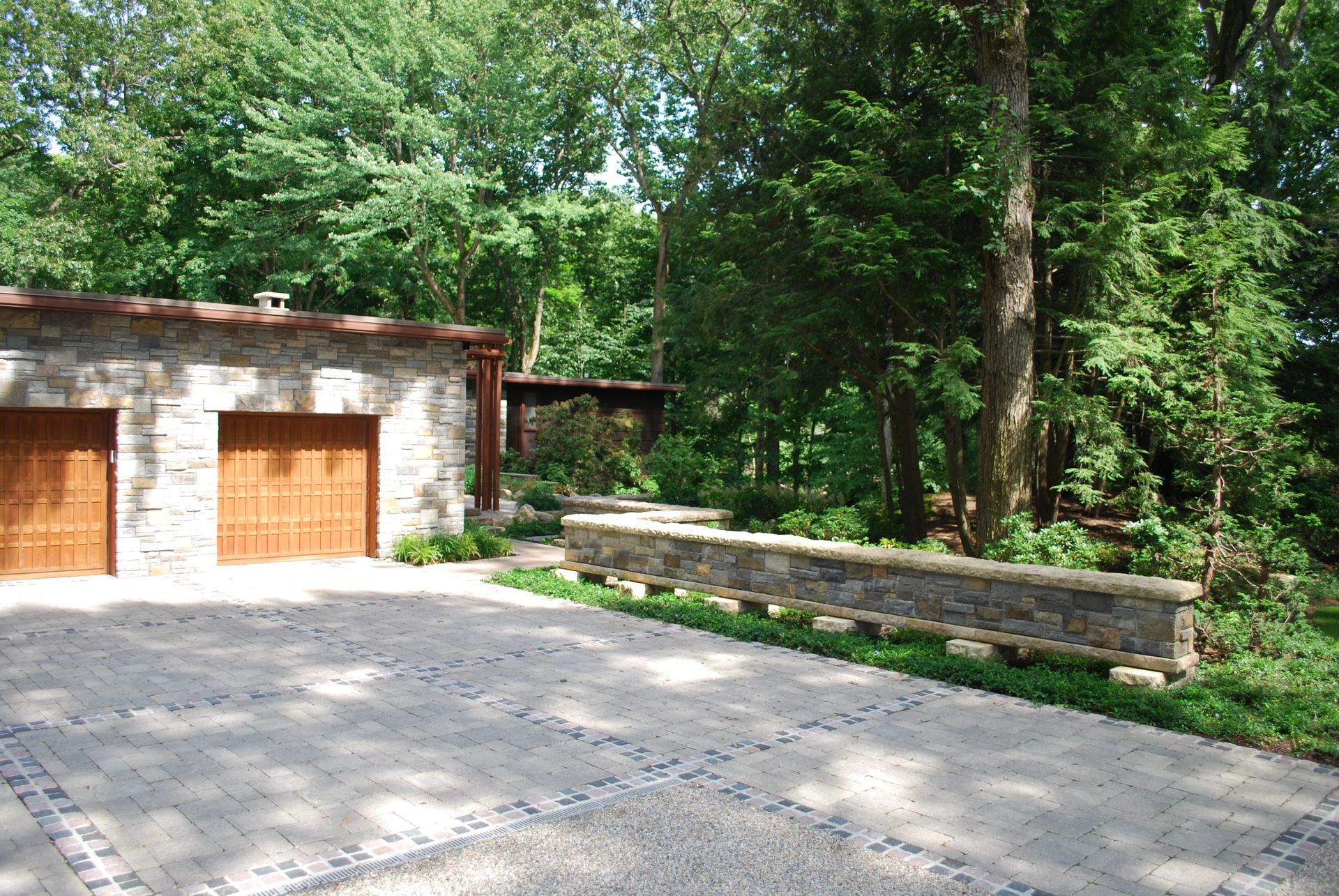 A driveway leading to a house with two garage doors