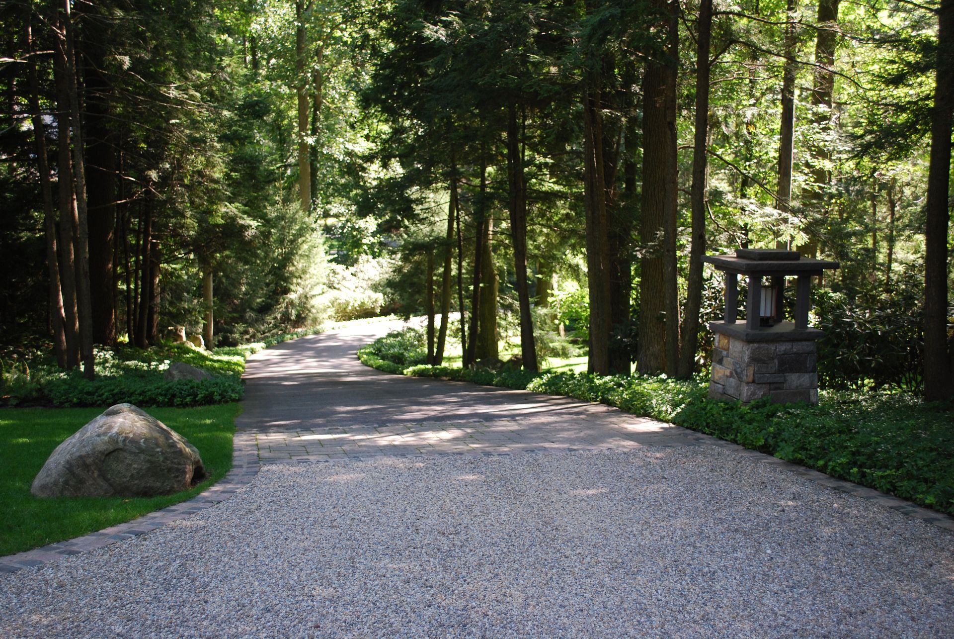 A gravel driveway in the middle of a forest