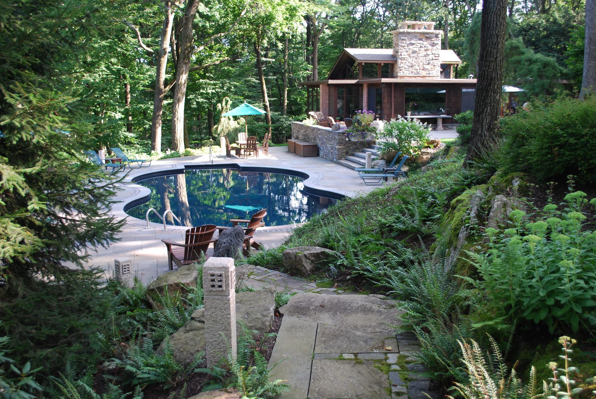 A large swimming pool in the middle of a forest