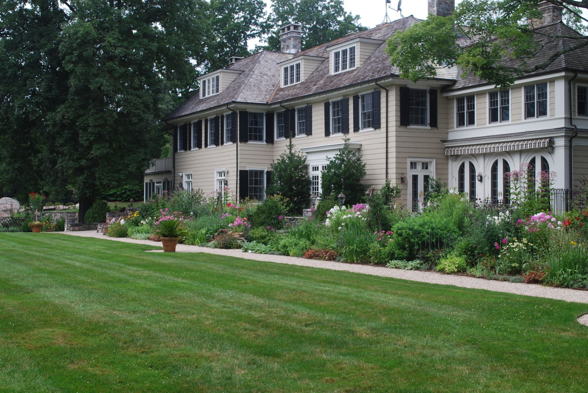 A large house with a lush green lawn in front of it