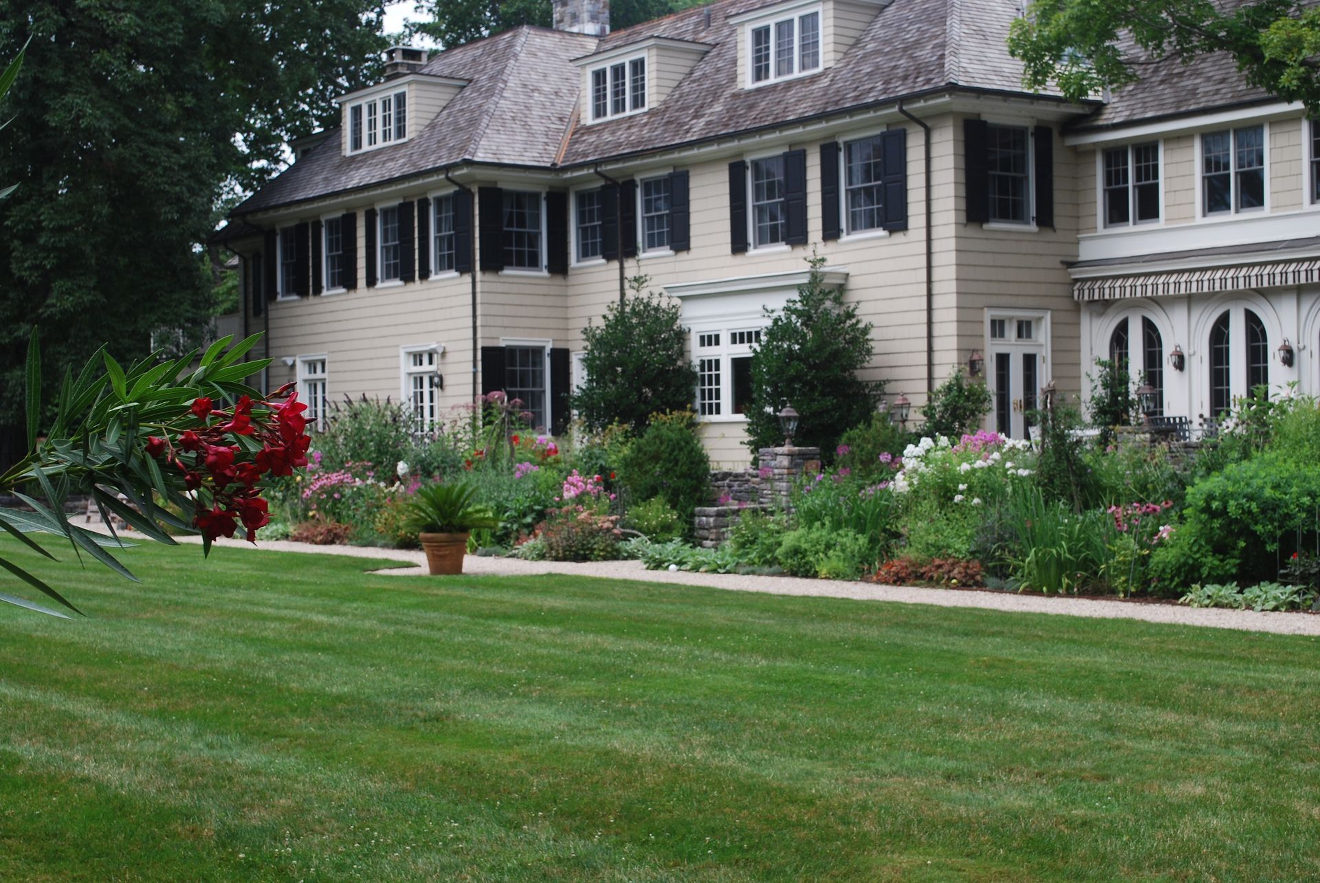 A large house with a lush green lawn in front of it