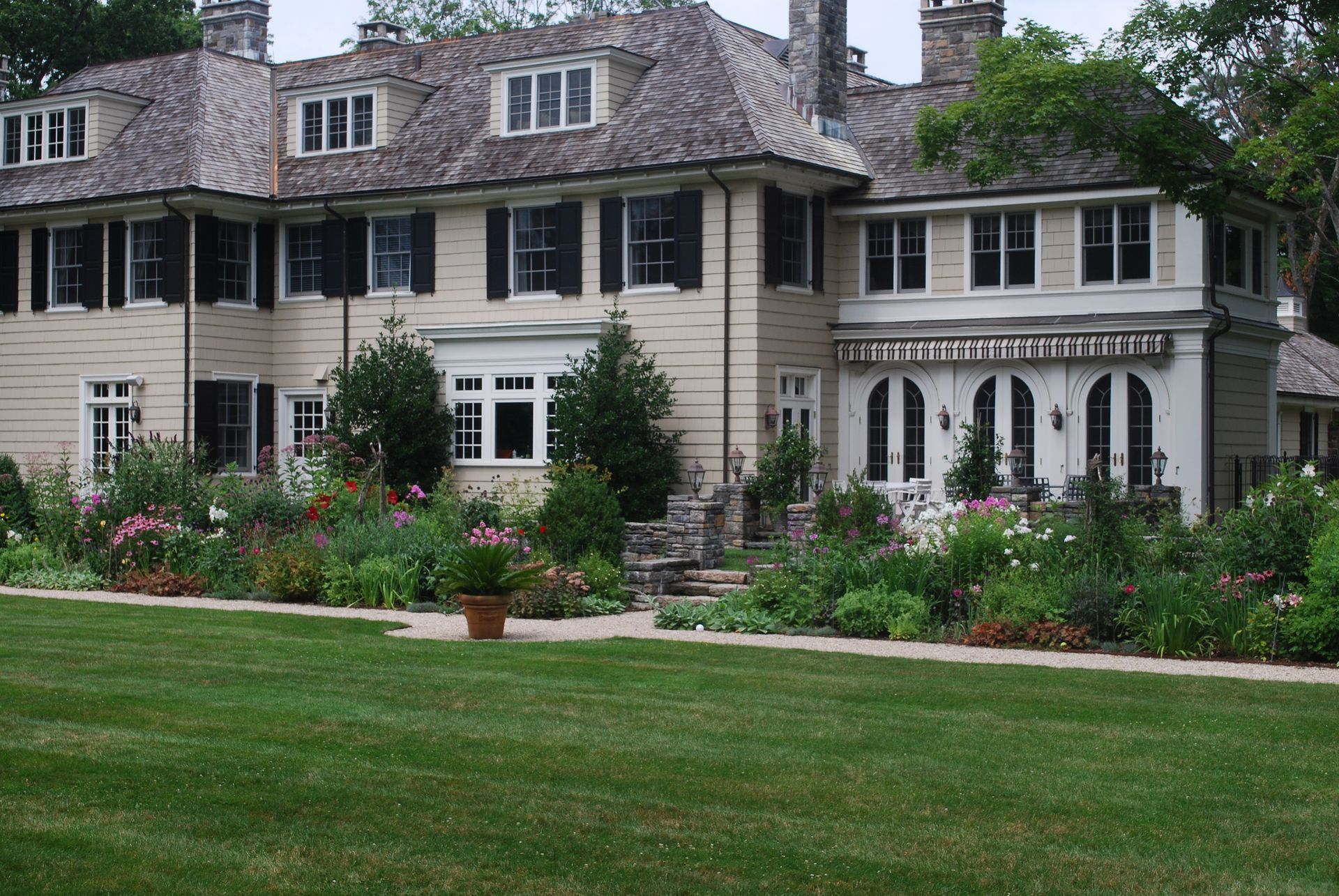 A large house with a lush green lawn in front of it