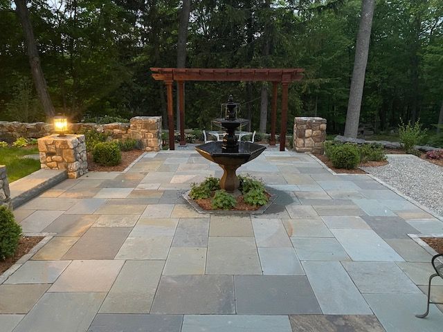 There is a fountain in the middle of the patio.