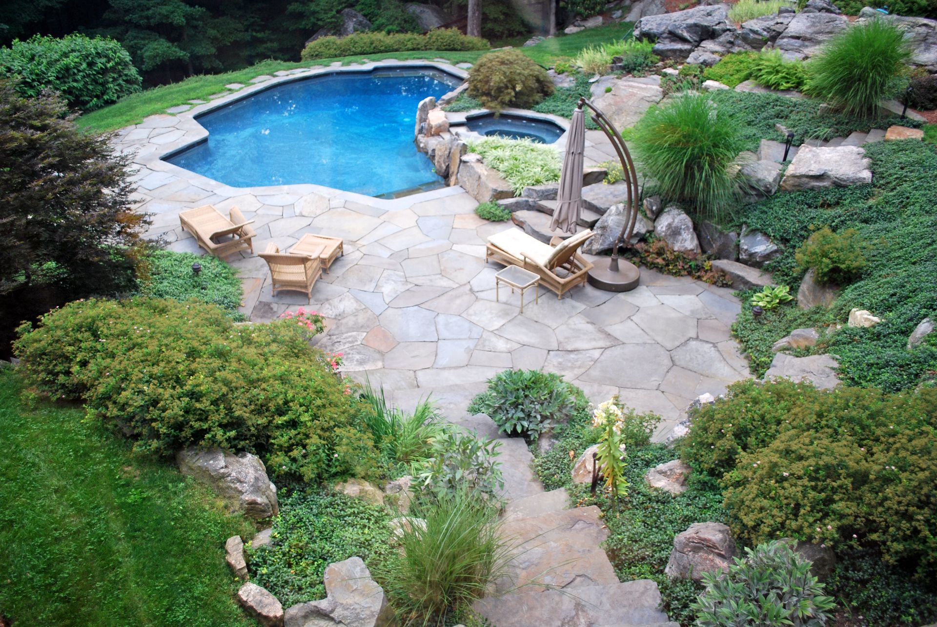 An aerial view of a backyard with a large swimming pool