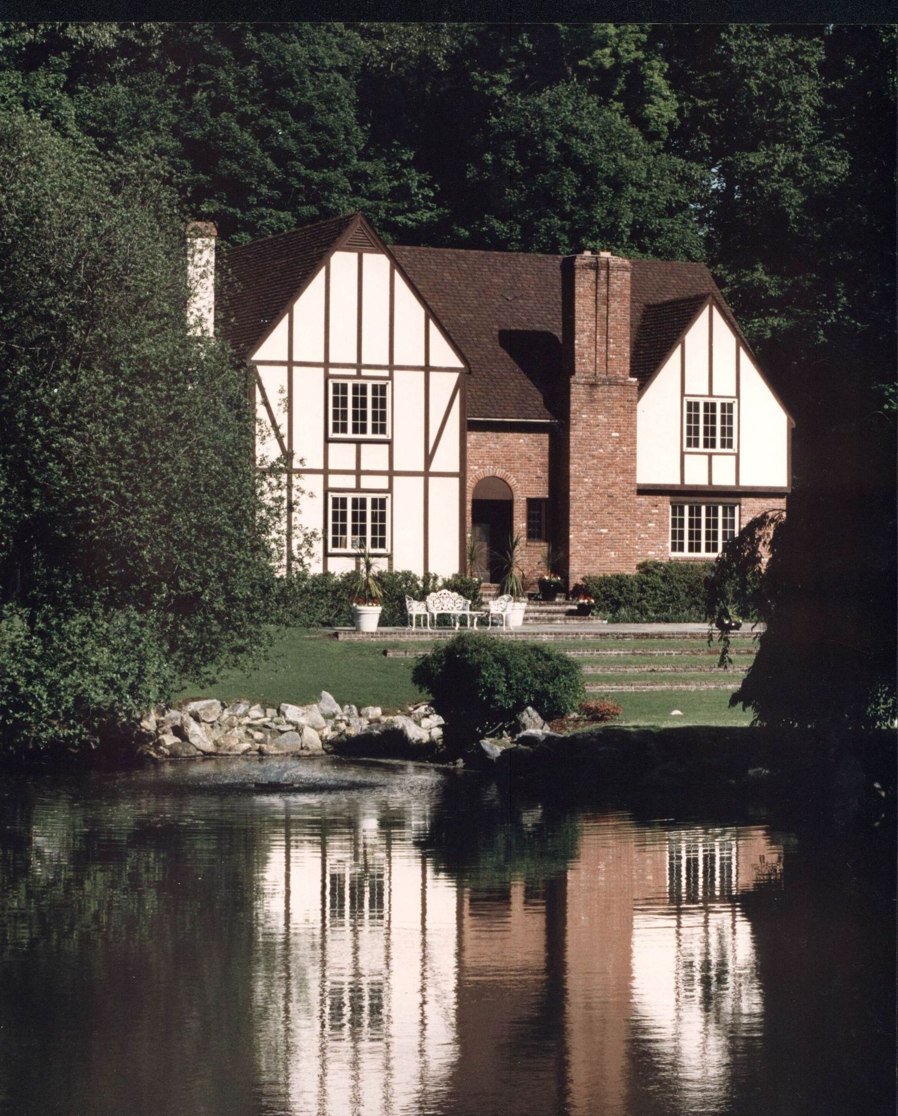 A house with a pond in front of it