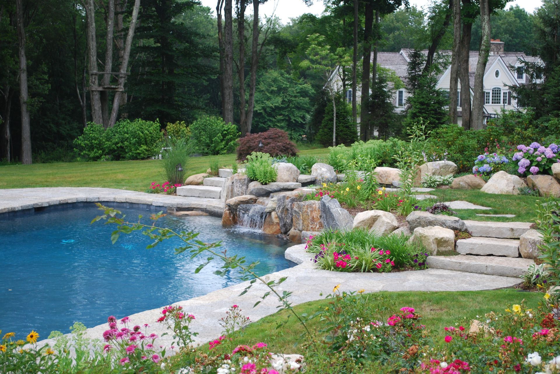 A swimming pool with a waterfall in the middle of it