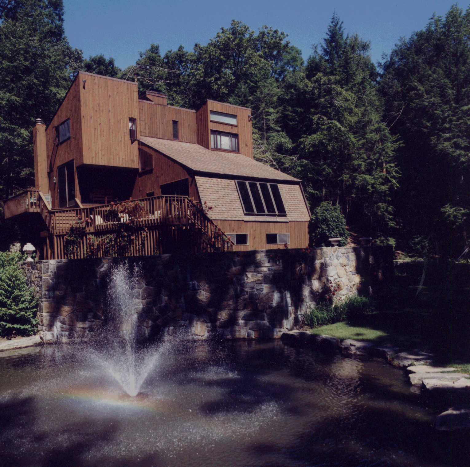 A house with a fountain in front of it