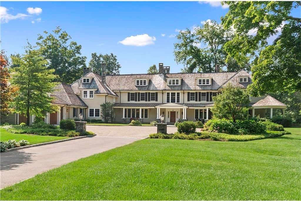 A large white house with a driveway leading to it