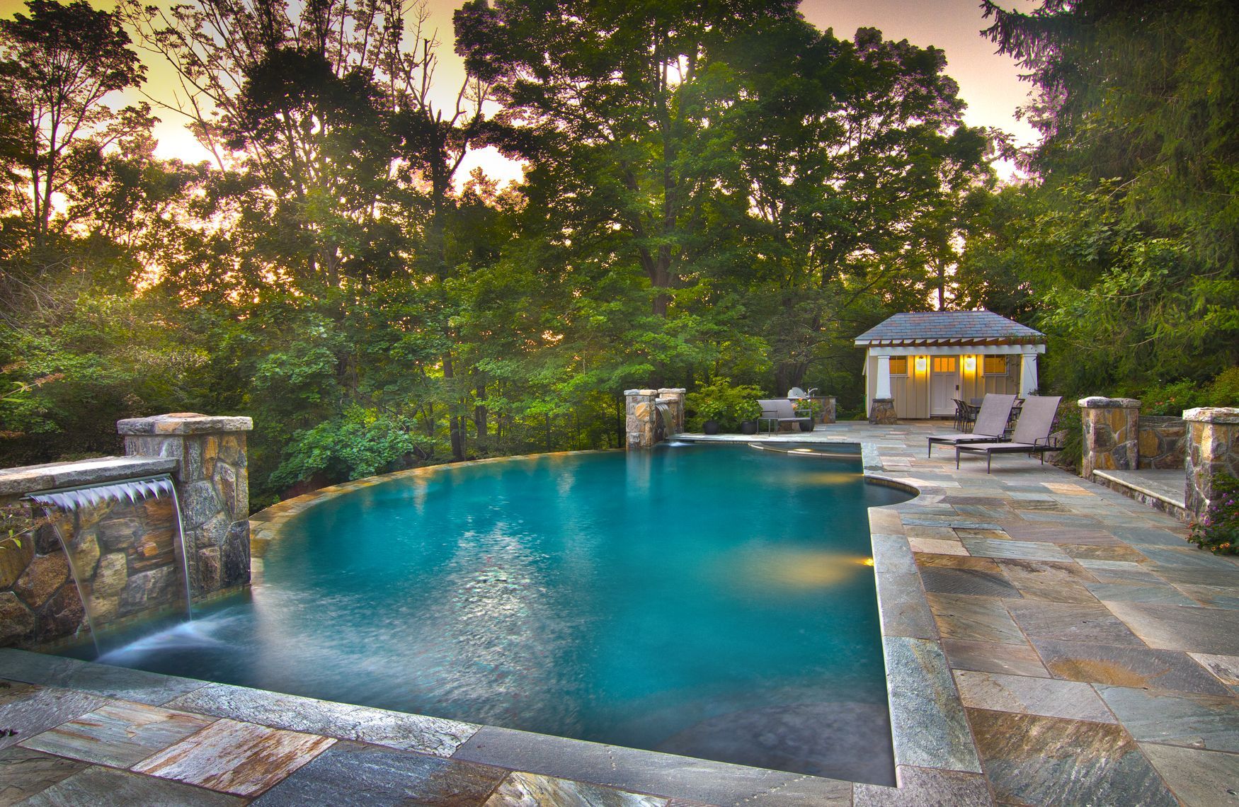 A large swimming pool with a gazebo in the background