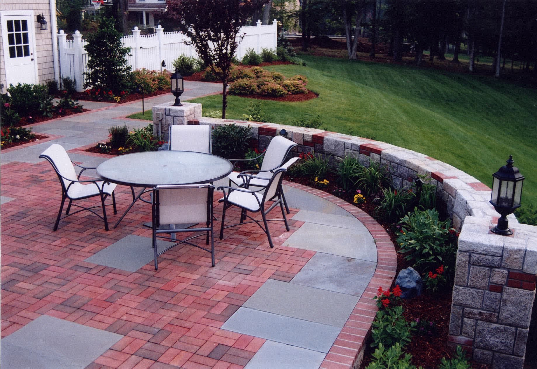 A patio with a table and chairs on it