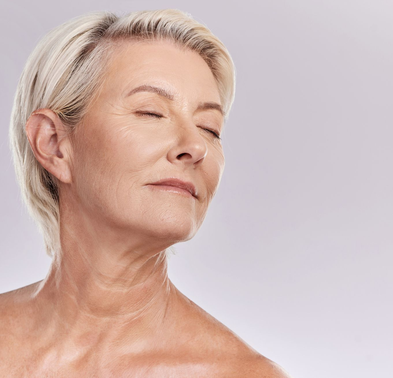  A woman with closed eyes is  turning her neck