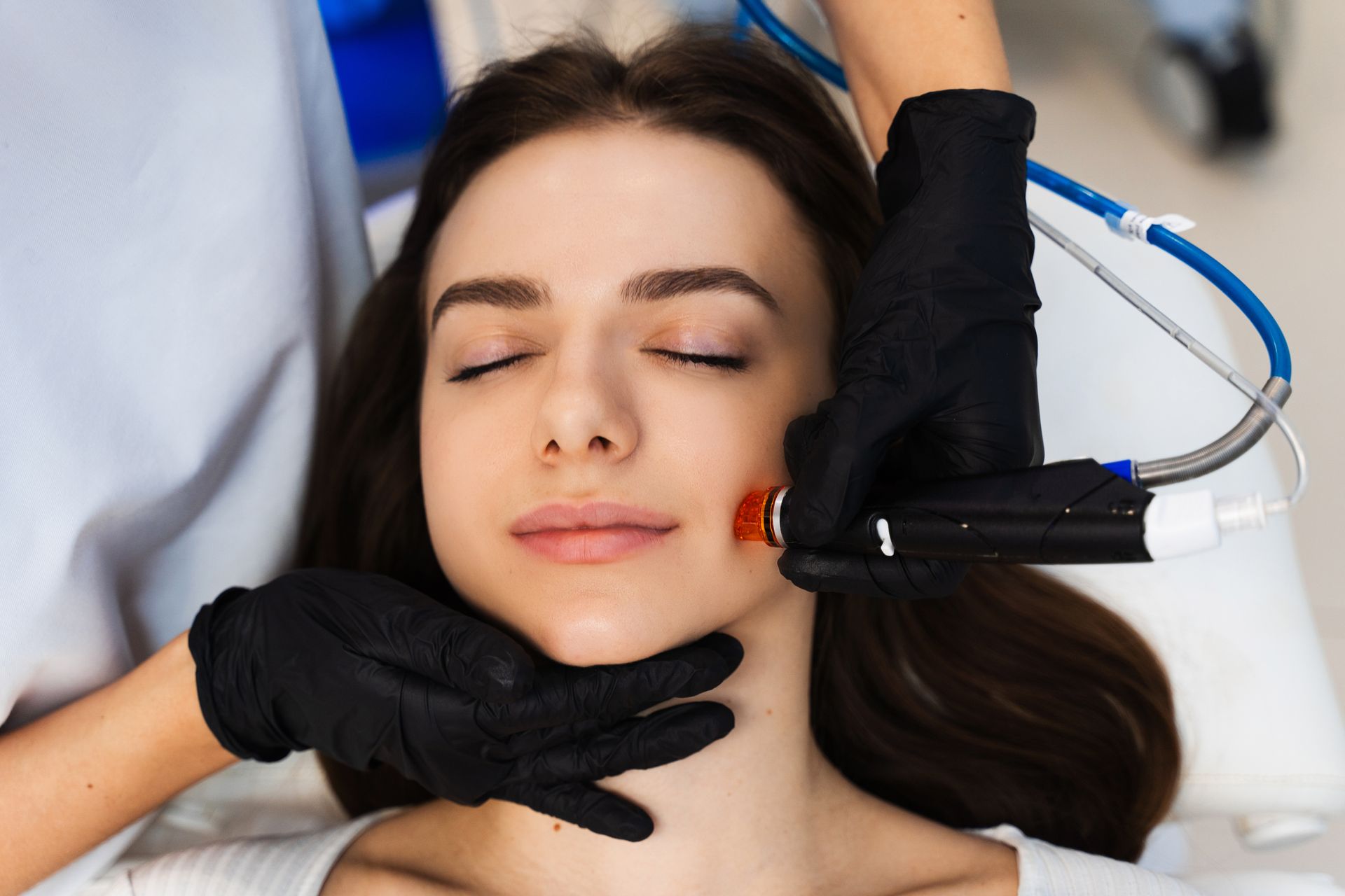 A woman is getting a facial treatment at a beauty salon.