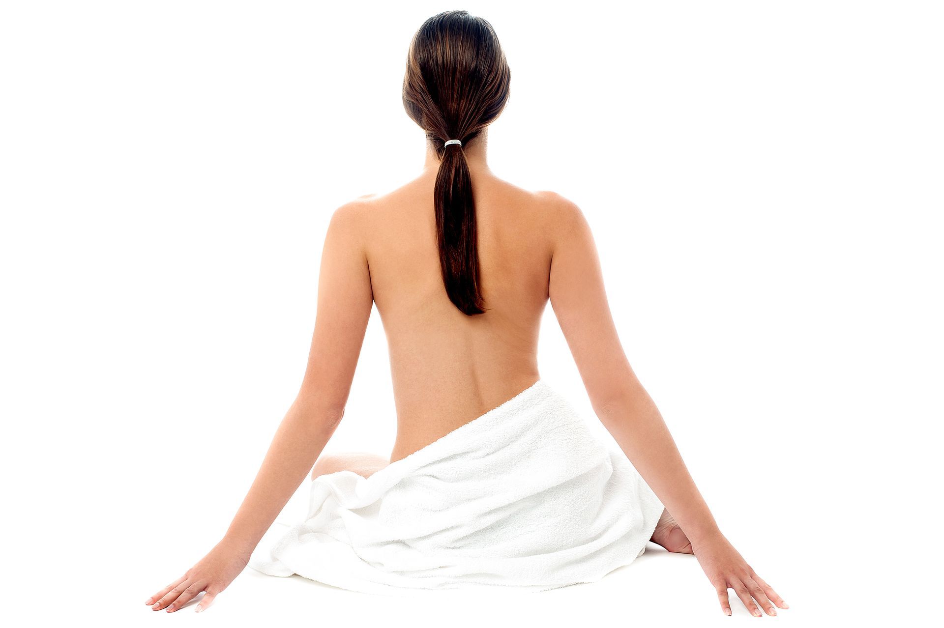 The back of a woman wrapped in a white towel