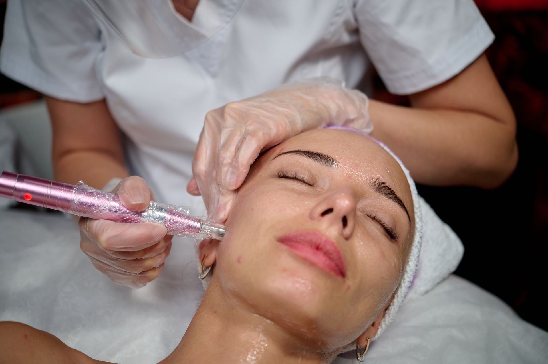 A woman is getting a facial treatment at a beauty salon.