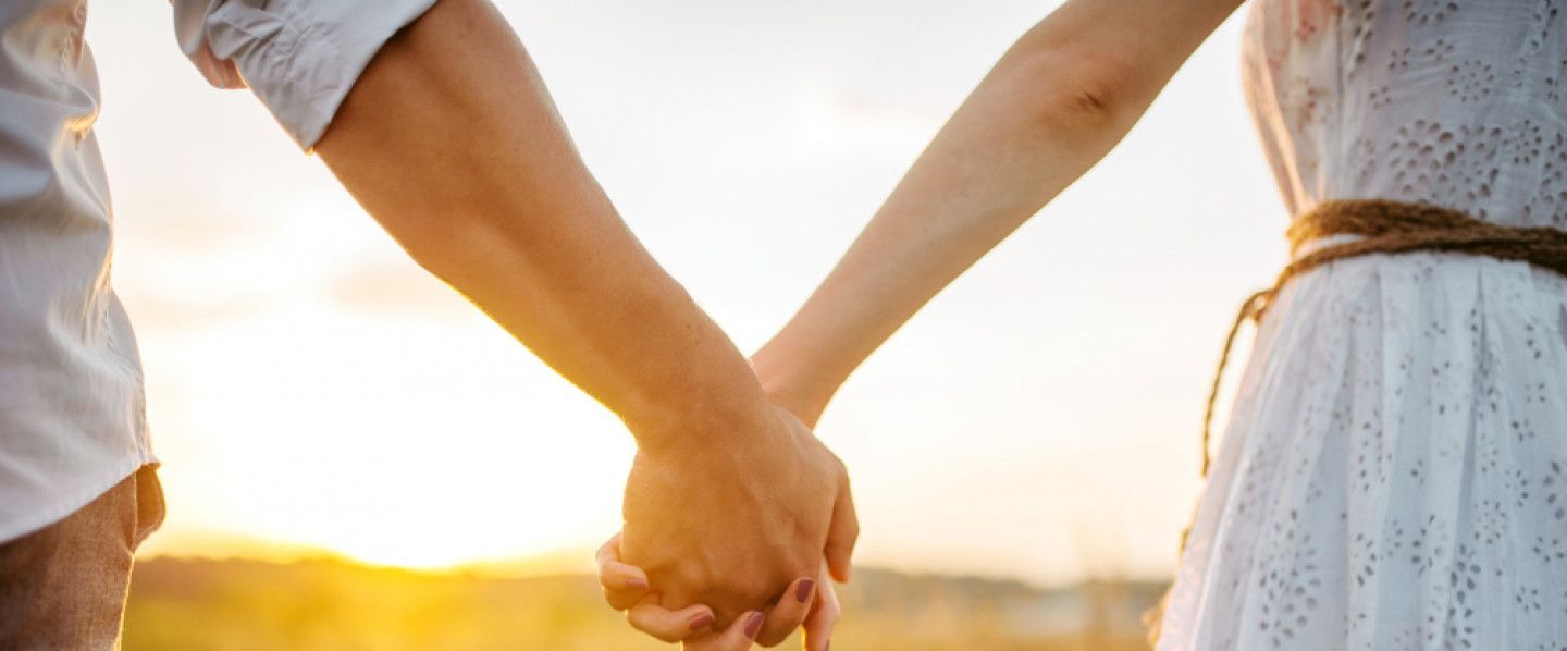 a man in a green shirt is being comforted by a woman .
