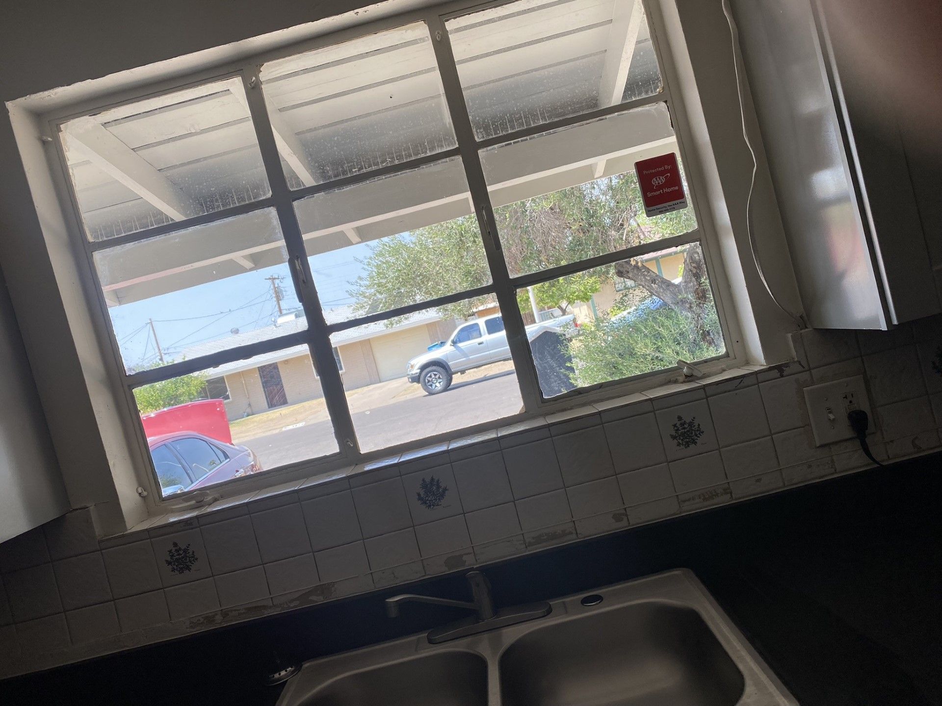 a kitchen with a sink and a window with a view of the street . | Litchfield Park, AZ | Cleaning Elite